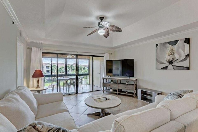 tiled living room featuring crown molding, a tray ceiling, and ceiling fan