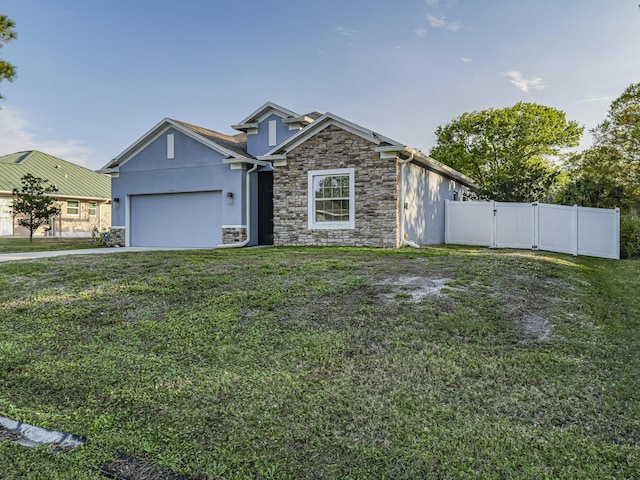 view of front of house featuring a garage and a front lawn