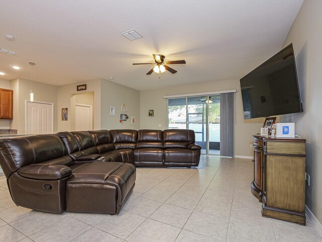 tiled living room with lofted ceiling and ceiling fan