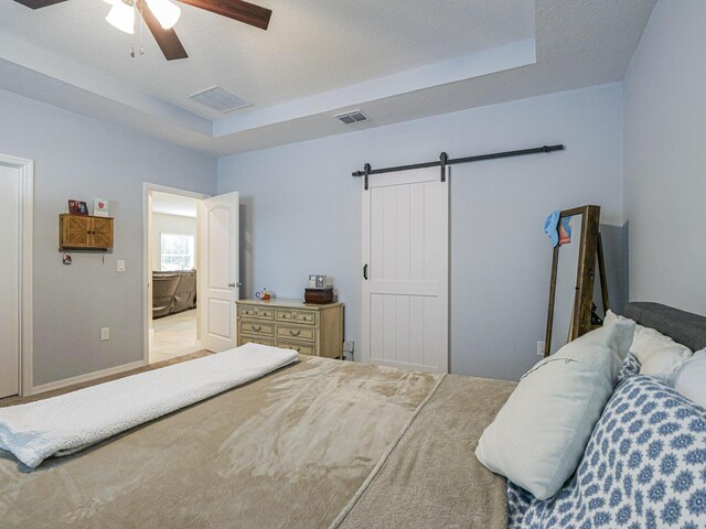 bedroom featuring ceiling fan and a raised ceiling