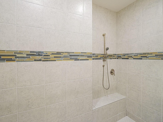 bathroom with a tile shower