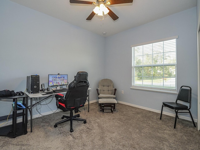 carpeted office space featuring ceiling fan