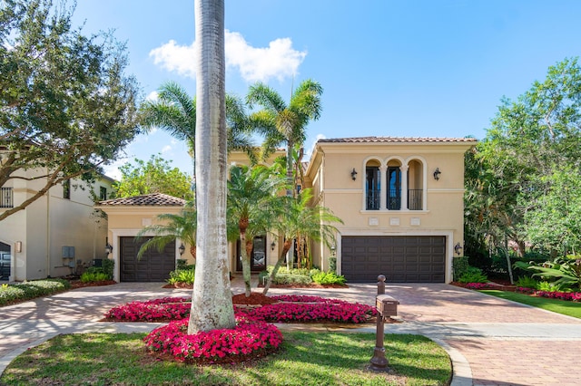 mediterranean / spanish home featuring a garage