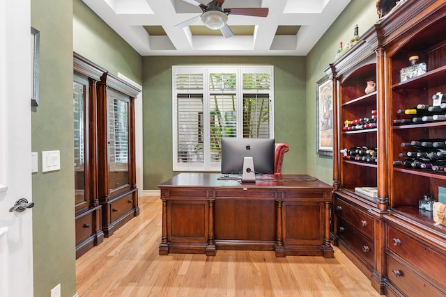 office area with coffered ceiling, light hardwood / wood-style floors, and ceiling fan