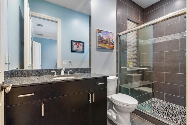 bathroom featuring walk in shower, ornamental molding, vanity, and toilet