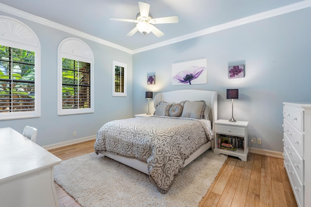 bedroom with ceiling fan, ornamental molding, and light hardwood / wood-style floors