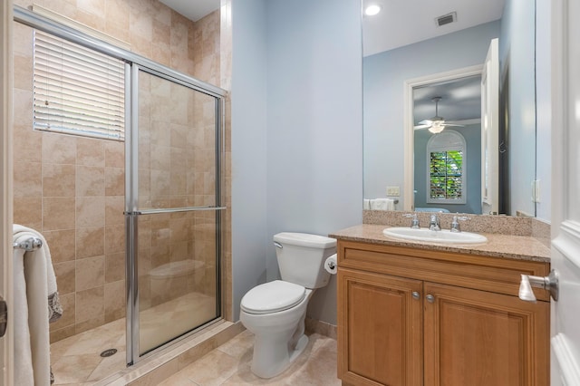 bathroom with vanity, a shower with shower door, tile patterned floors, and toilet