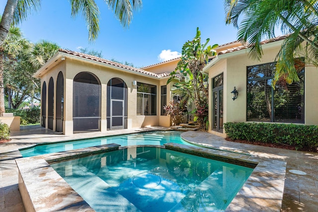 back of property featuring a patio area and a sunroom