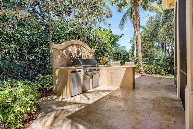 view of patio with a grill and an outdoor kitchen