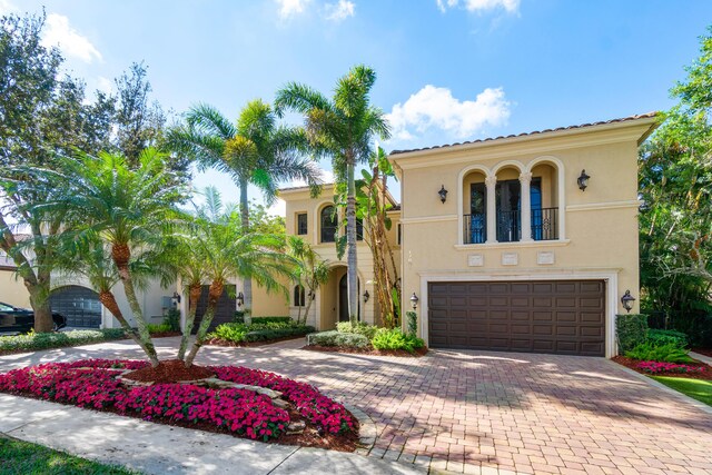 mediterranean / spanish home with a garage