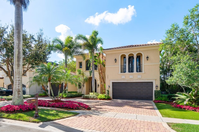 mediterranean / spanish home featuring a garage