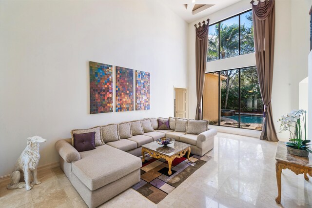 living room with a notable chandelier and a high ceiling