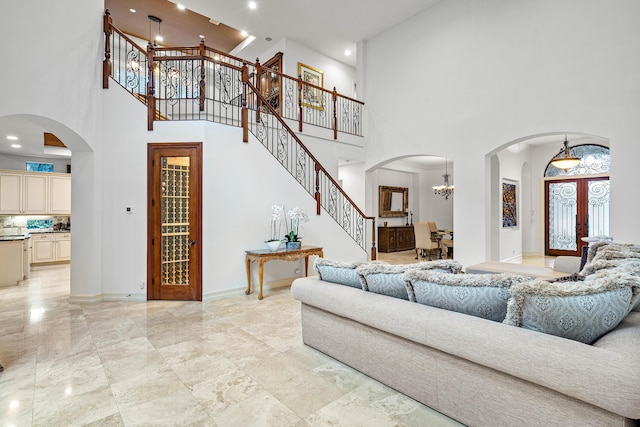 living room featuring a high ceiling and a chandelier