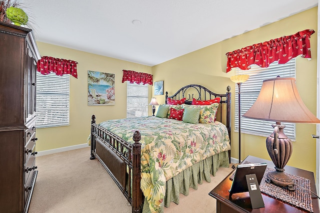 carpeted bedroom with multiple windows