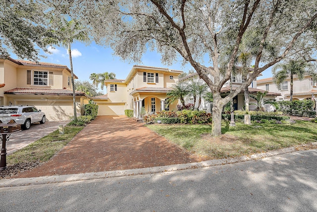 mediterranean / spanish house with a garage and a front yard