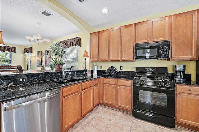 kitchen featuring light tile patterned flooring, sink, dark stone countertops, black appliances, and an inviting chandelier