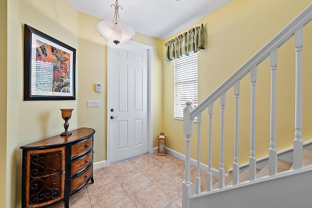 entrance foyer featuring light tile patterned floors