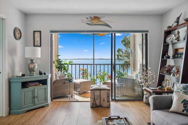 living room with hardwood / wood-style floors and a water view