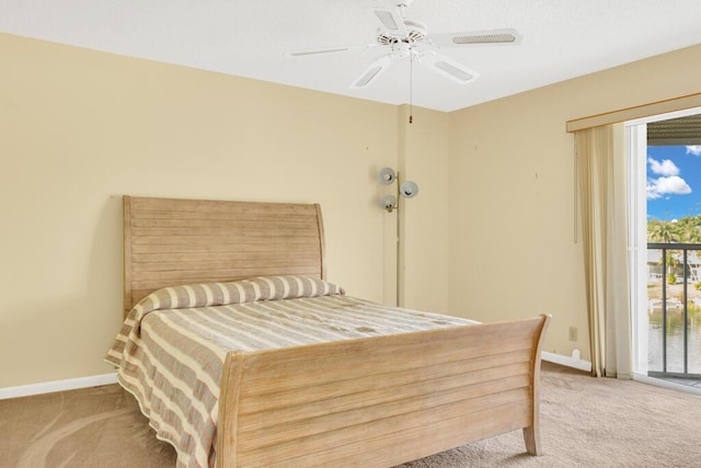 carpeted bedroom featuring access to exterior, ceiling fan, and baseboards