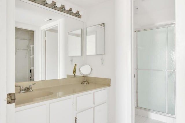 bathroom featuring a stall shower, visible vents, and vanity