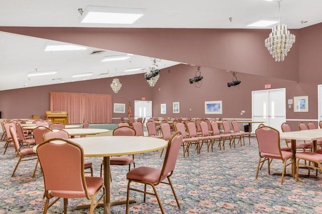 dining area with high vaulted ceiling, carpet flooring, and a chandelier