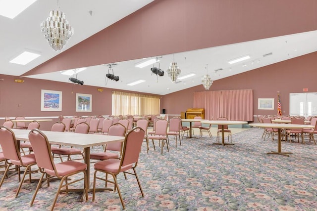 carpeted dining room featuring an inviting chandelier and high vaulted ceiling