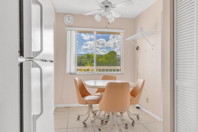 dining space featuring light tile patterned floors and ceiling fan