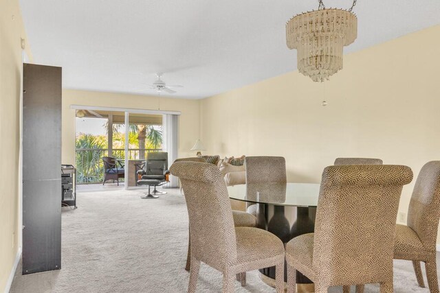 carpeted dining room with a notable chandelier and a textured ceiling