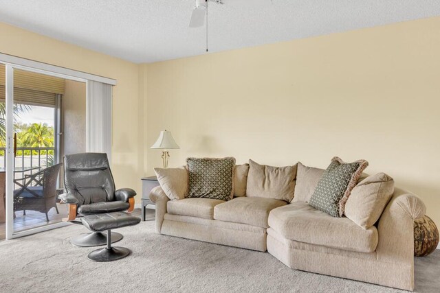 living room featuring ceiling fan and light carpet