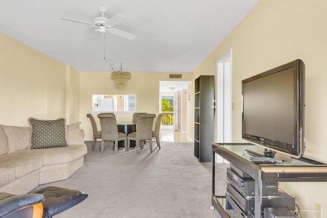 carpeted living room with visible vents and a ceiling fan