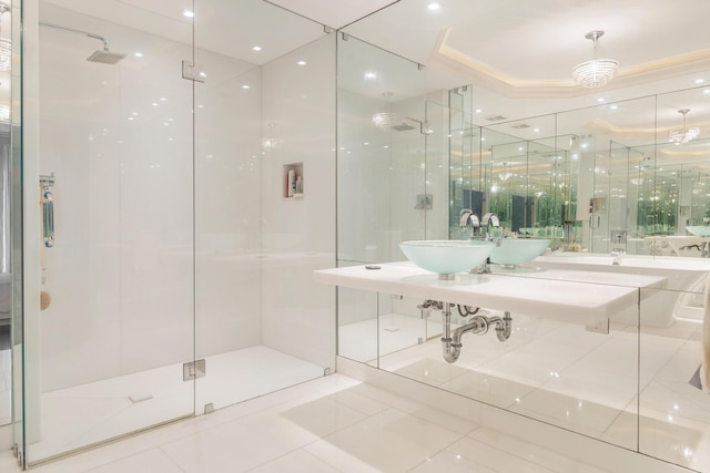 bathroom featuring a shower stall, a raised ceiling, and a sink