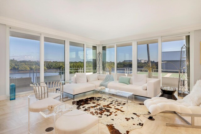 living room with expansive windows and ornamental molding