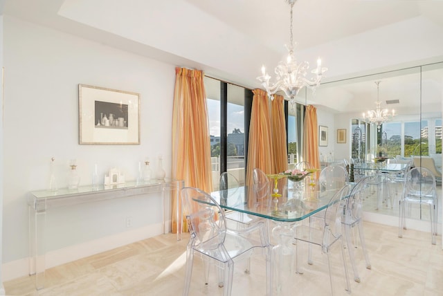 unfurnished dining area featuring an inviting chandelier, baseboards, floor to ceiling windows, and a tray ceiling