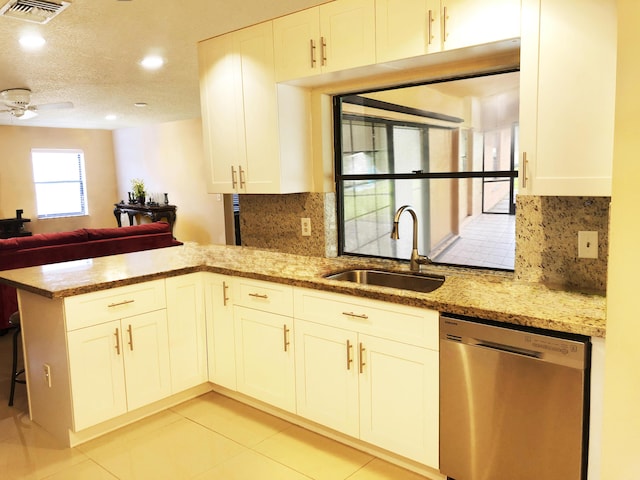 kitchen featuring sink, stainless steel dishwasher, white cabinets, and kitchen peninsula