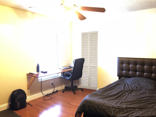 bedroom featuring hardwood / wood-style flooring and ceiling fan