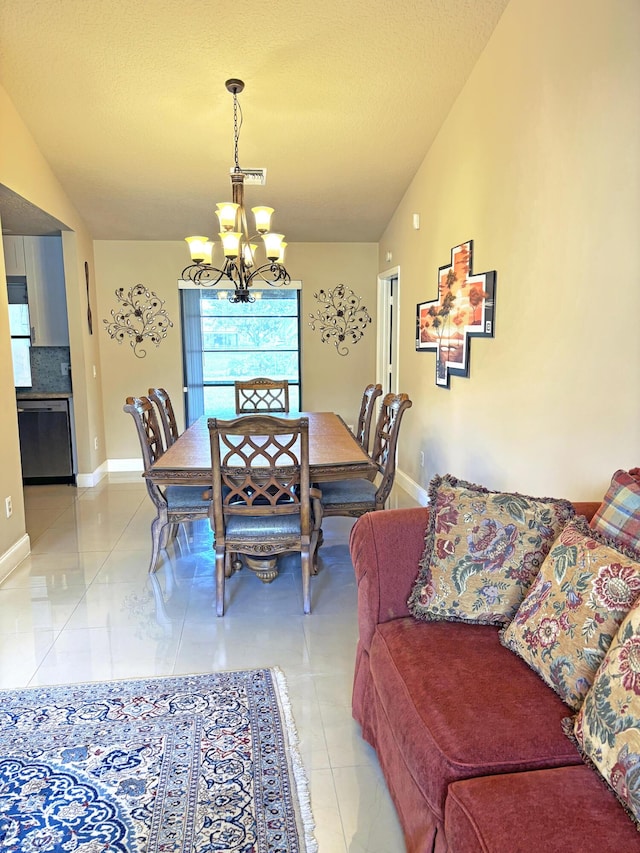 tiled dining space featuring lofted ceiling, a textured ceiling, and an inviting chandelier