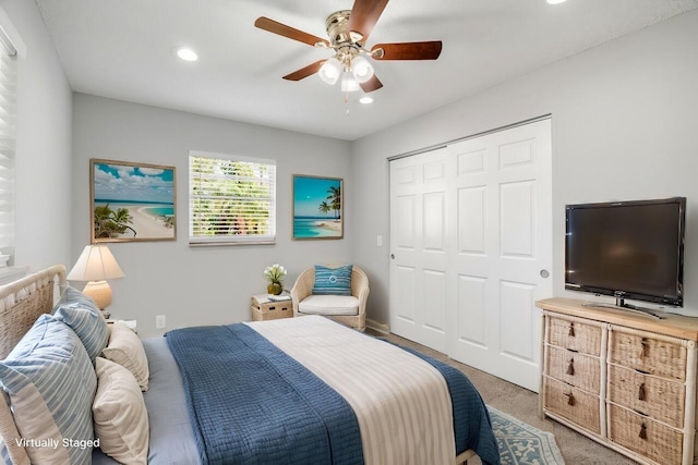 bedroom with carpet flooring, ceiling fan, and a closet