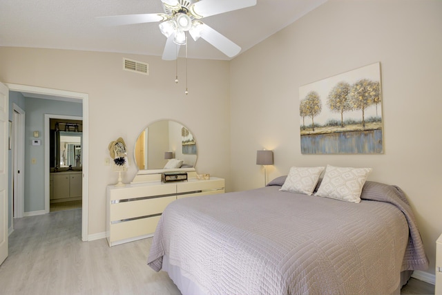 bedroom with ceiling fan, lofted ceiling, and light wood-type flooring