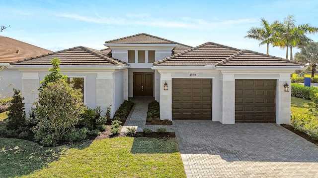 view of front of property with a garage and a front lawn