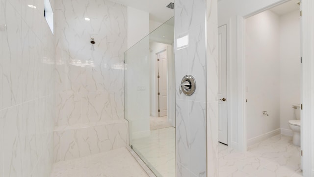 bathroom with tiled shower and toilet