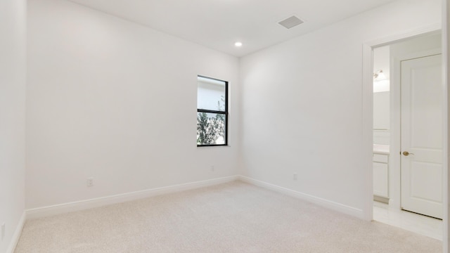 empty room featuring light colored carpet