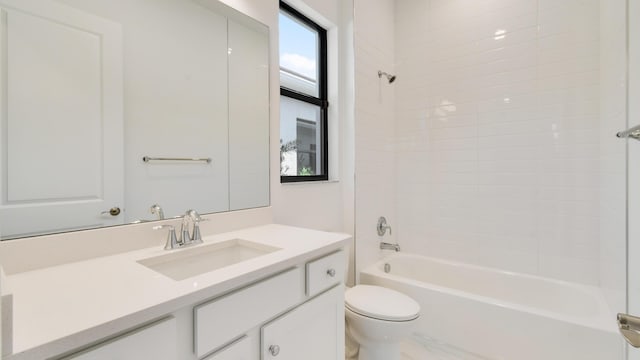 full bathroom with vanity, tiled shower / bath, and toilet