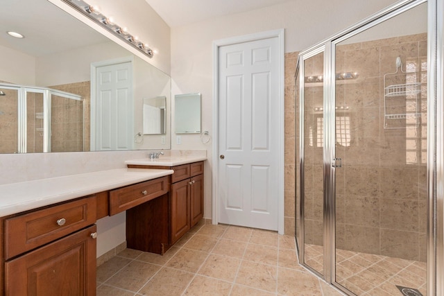 bathroom featuring tile patterned floors, vanity, and an enclosed shower