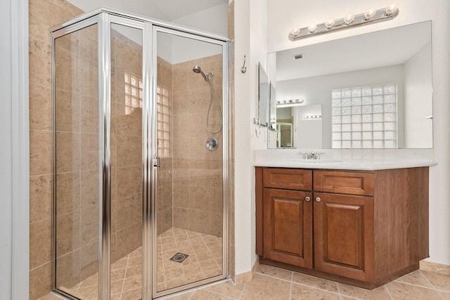 bathroom with walk in shower and vanity