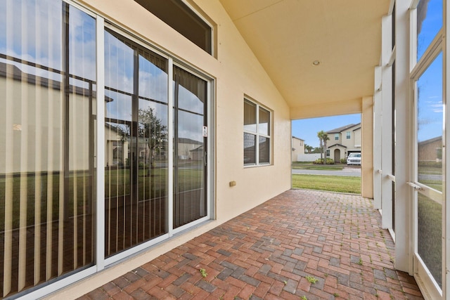 unfurnished sunroom featuring lofted ceiling