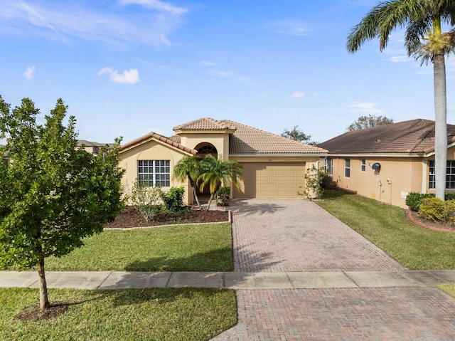 mediterranean / spanish-style house featuring a garage and a front lawn