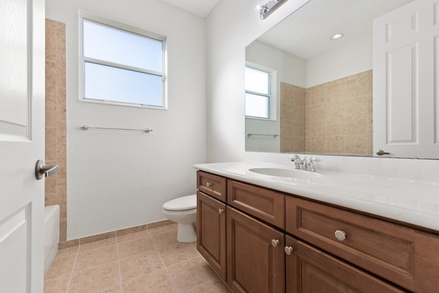 bathroom featuring tile patterned floors, vanity, and toilet