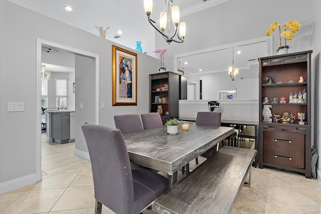 tiled dining area featuring crown molding and a notable chandelier