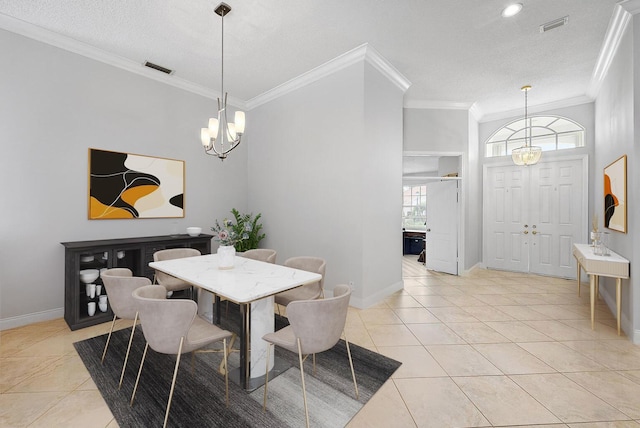 dining space with crown molding, baseboards, visible vents, and a chandelier