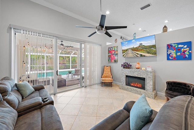 tiled living room with ceiling fan and ornamental molding